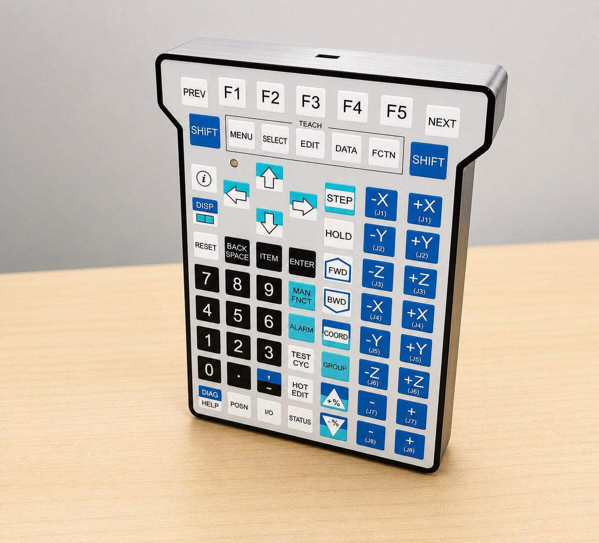 The USB FANUC teach pendant at a three-quarter angle, showing the full keypad face and its slim profile.